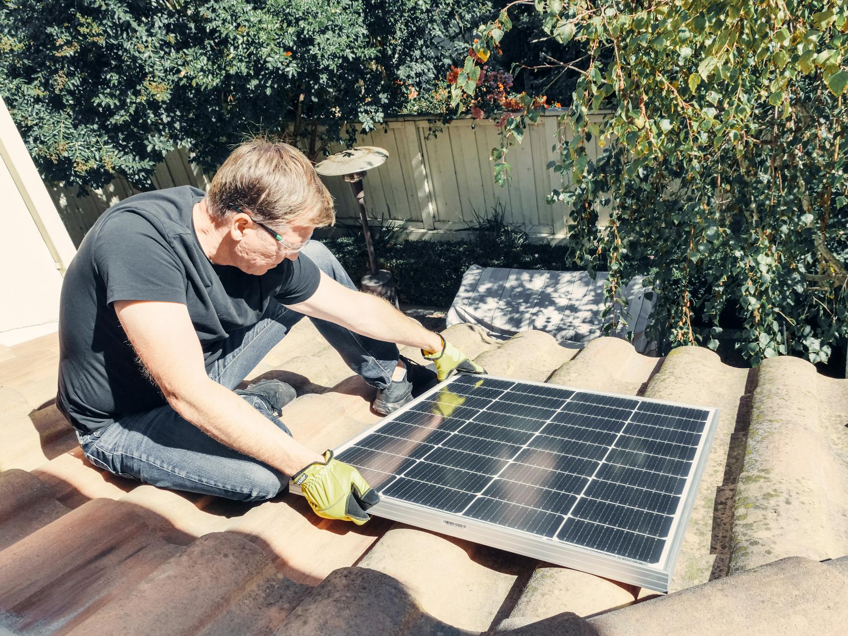 A roofing professional inspecting a concrete tile roof on a home in Las Vegas, checking for cracked tiles and worn underlayment.